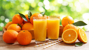 Glasses,Of,Fresh,Orange,Juice,With,Fresh,Fruits,Over,A